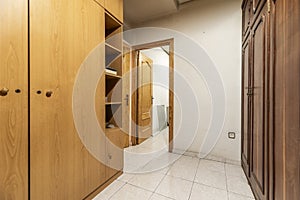 A room with walls lined with wardrobes with folding beds