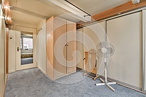 a room with a wardrobe and a fan