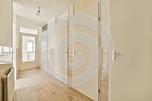 a room with white closets and a wood floor