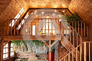 Room with wooden stairway leading to second floor of modern flat. Scandinavian style at home.