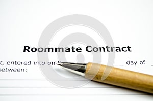Roommate contract with wooden pen