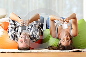 Roommates online with smart phones upside down photo
