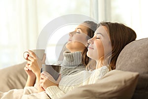 Roommates relaxing in winter on a couch photo