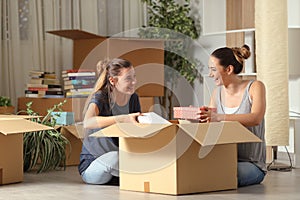 Roommates talking unboxing gelongings moving home photo