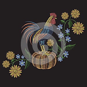 Rooster standing on pumpkin, sunflowers and hepatica flower