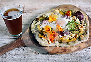 Root vegetables pizza with cottage cheese, egg and flowers