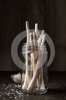 Roots of horseradish in a glass jar