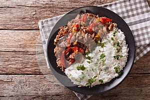 Ropa vieja: beef stew in tomato sauce with vegetables and rice. photo