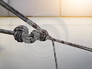 Rope access for cleaning worker wearing safety harness hard hat working at height descending on rope performing washes a hospital.