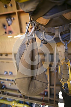 Rope access equipment accessories brawn tool bag hanging on the side of inspector abseiler safety harness loop