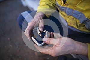 Rope access inspector hand commencing daily safety checking inspecting locking Carabiner defective equipment