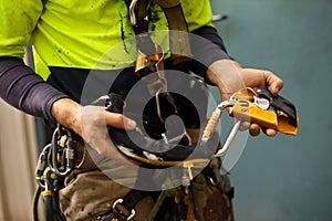 Rope access inspector inspecting self controlled stop a fall descent safety device