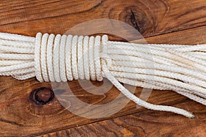 Rope alpine coil knot on an old wooden table