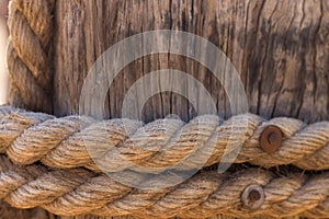 Rope around wood pillar nautical ship object, wooden background texture