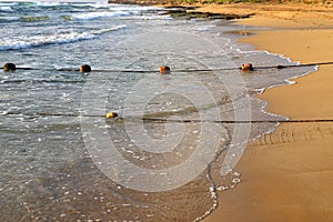 Rope on the beach to enclose a permitted swimming spot