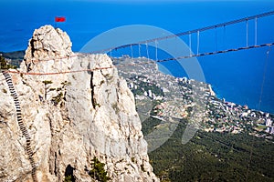 Rope bridge above chasm on Mount Ai-Petri overlooking Black Sea coast, Crimea