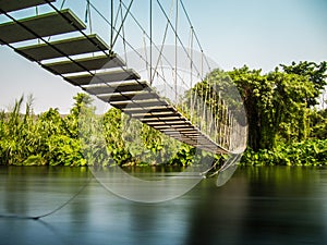 Rope bridge across river.
