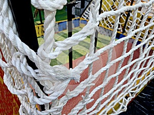 a rope cage for children on the pirate-themed playground, a fishing net