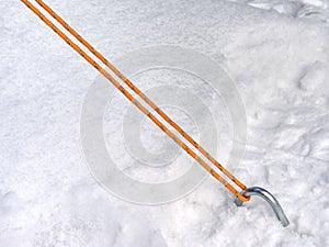 Rope on a camp tent, detail of anchored tent in snowy ground