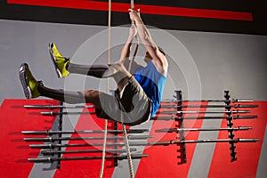 Rope Climb exercise man workout at gym