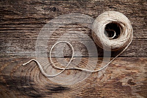 Rope coil on old wooden background