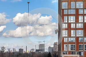 The rope of a construction cargo crane on a background of blue sky with clouds
