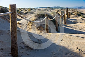 Rope fence on the sandy beach of La Mata. Sunset on the beach. Blurred unfocused background 03