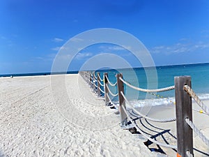 Rope fence and shadow on the beach.