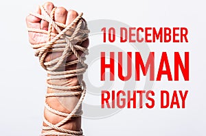 Rope on fist hand with 10 december HUMAN RIGHTS DAY text