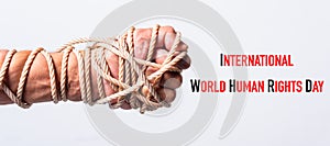 Rope on fist hand with international World HUMAN RIGHTS DAY text