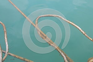 Rope floating on surface of the deep blue sea background.