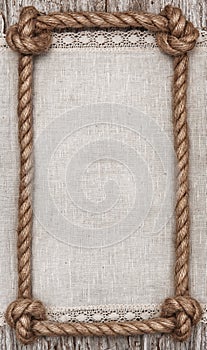 Rope frame, linen fabric and wood background