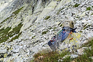 Rope, helmet, carabiners, climbing harness and descender on the rock