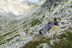 Rope, helmet, carabiners, climbing harness and descender on a rock in the valley