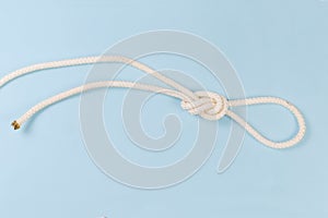 Rope knot as overhand loop on a blue background