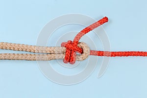 Rope knot Duble sheet bend on blue background close-up