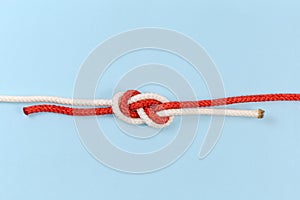 Rope knot Flemish bend on a blue background