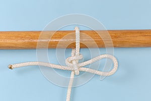 Rope knot Highpoint hitch tied around a wooden pole