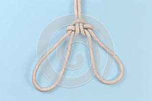 Rope knot Spanish bowline on a blue background