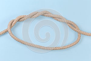 Rope knot Threefold overhand knot on a blue background photo