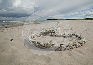 Rope laying in sand. GN