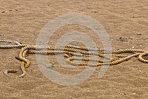 The rope lies on the beach on the Mediterranean