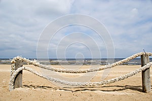 Rope log fence beach sand