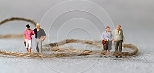 Rope and miniature people with business concept.