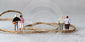 Rope and miniature people with business concept.