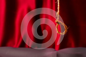 Rope noose over red background