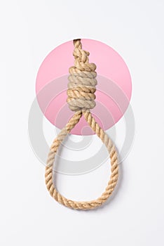 Rope noose with tight hangman knot layered white paper background