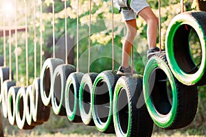 Rope park. A boy passes an obstacle on tires in a rope Park.