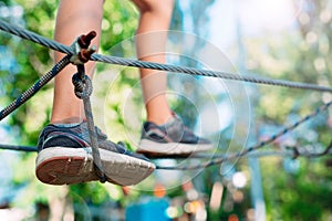 Rope Park. close - up of a child`s feet passing an obstacle.