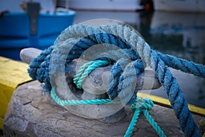Rope securing boat to wharf. Knot securing fishing boat.